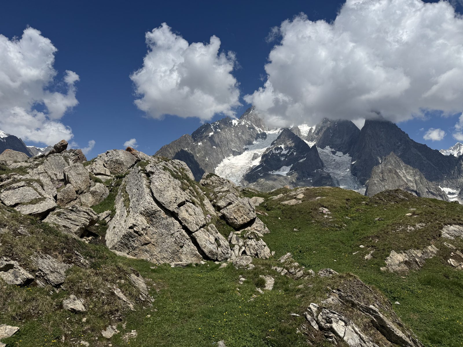 Snow-covered alpine peaks above a green valley