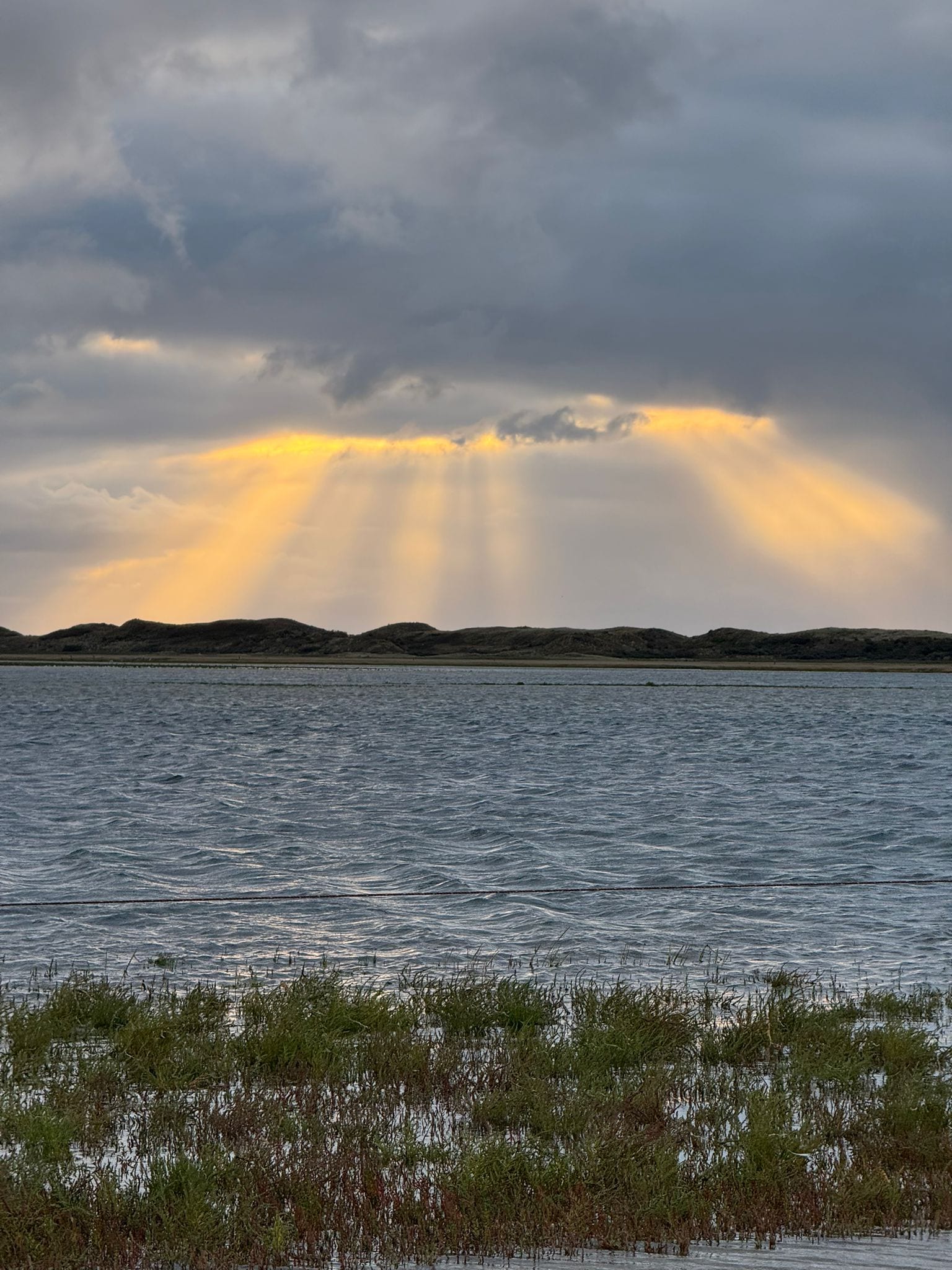Golden light breaking through cloud onto the North Sea off Texel